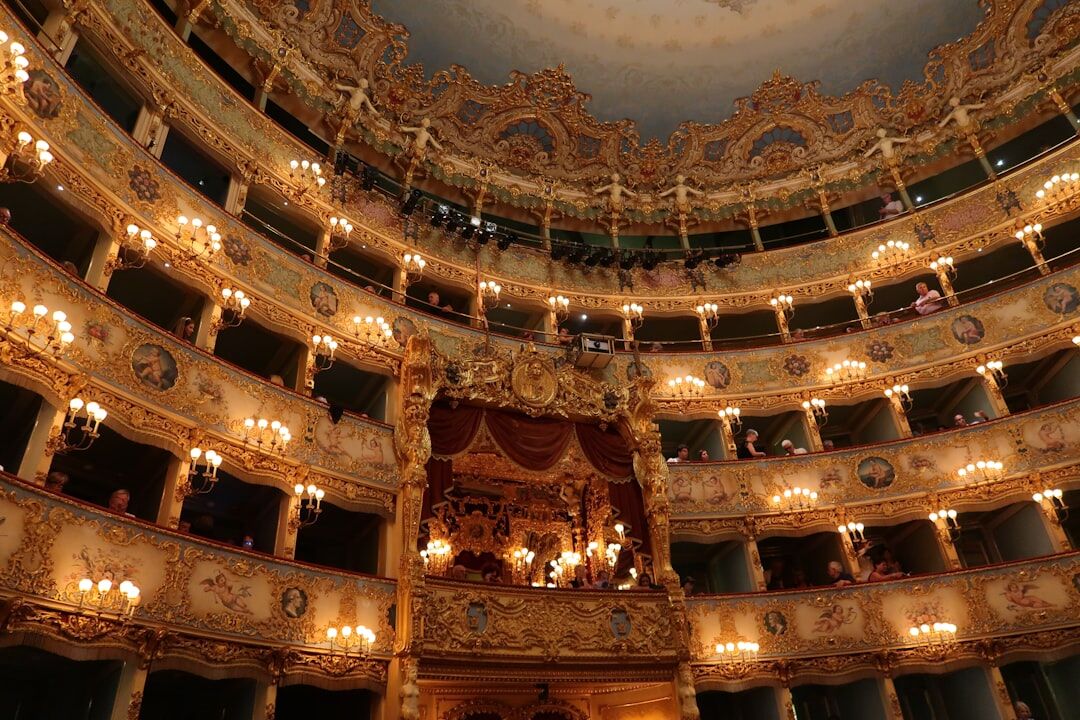 Grand theatre interior with red velvet seats and ornate balconies
